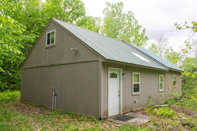 128 Beckwith Rd, Cornville, ME 04976 - view of home's exterior featuring metal roof and view of scattered trees