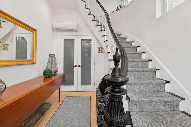 123 Cumberland Ave, Portland, ME 04101 - entrance foyer featuring stairs, french doors, a wall unit AC, wood finished floors, and a high ceiling