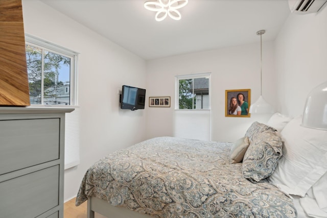 123 Cumberland Ave, Portland, ME 04101 - bedroom with a wall mounted AC, light wood finished floors, and multiple windows