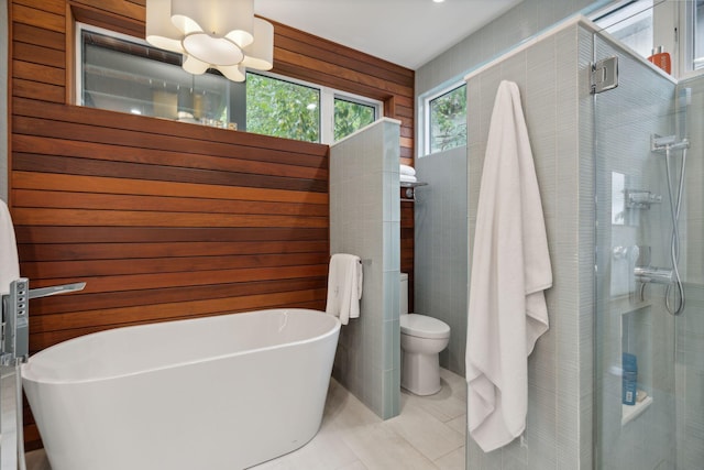 123 Cumberland Ave, Portland, ME 04101 - bathroom featuring a stall shower, a soaking tub, toilet, and tile patterned floors