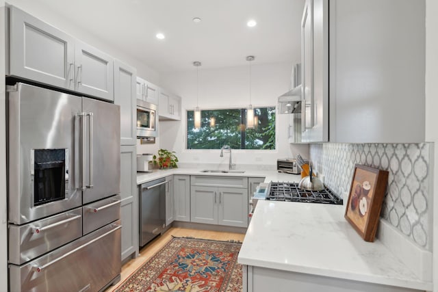 123 Cumberland Ave, Portland, ME 04101 - kitchen featuring appliances with stainless steel finishes, a sink, light wood-type flooring, pendant lighting, and recessed lighting