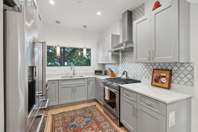 123 Cumberland Ave, Portland, ME 04101 - kitchen with appliances with stainless steel finishes, wall chimney exhaust hood, a sink, gray cabinetry, and recessed lighting