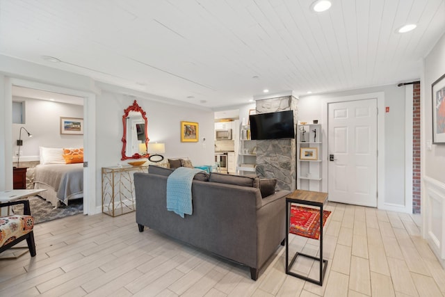 123 Cumberland Ave, Portland, ME 04101 - living area with light wood-style floors, recessed lighting, a large fireplace, and wood ceiling