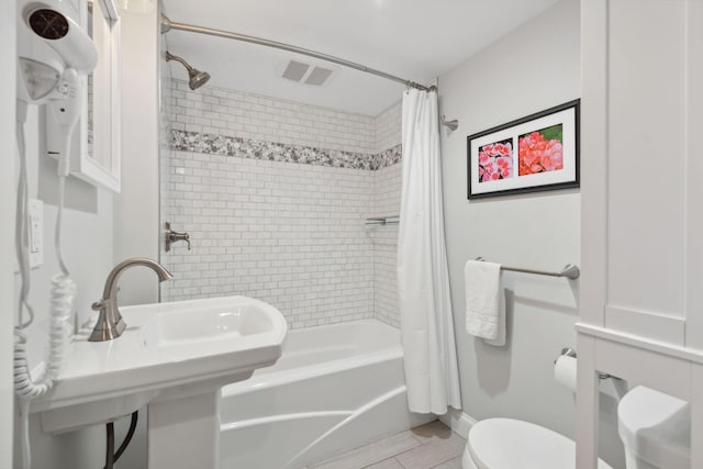 123 Cumberland Ave, Portland, ME 04101 - bathroom featuring toilet, shower / bathtub combination with curtain, and a sink