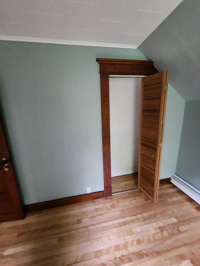 76 Somerset St, Millinocket, ME 04462 - unfurnished bedroom with light wood-type flooring, vaulted ceiling, and ornamental molding