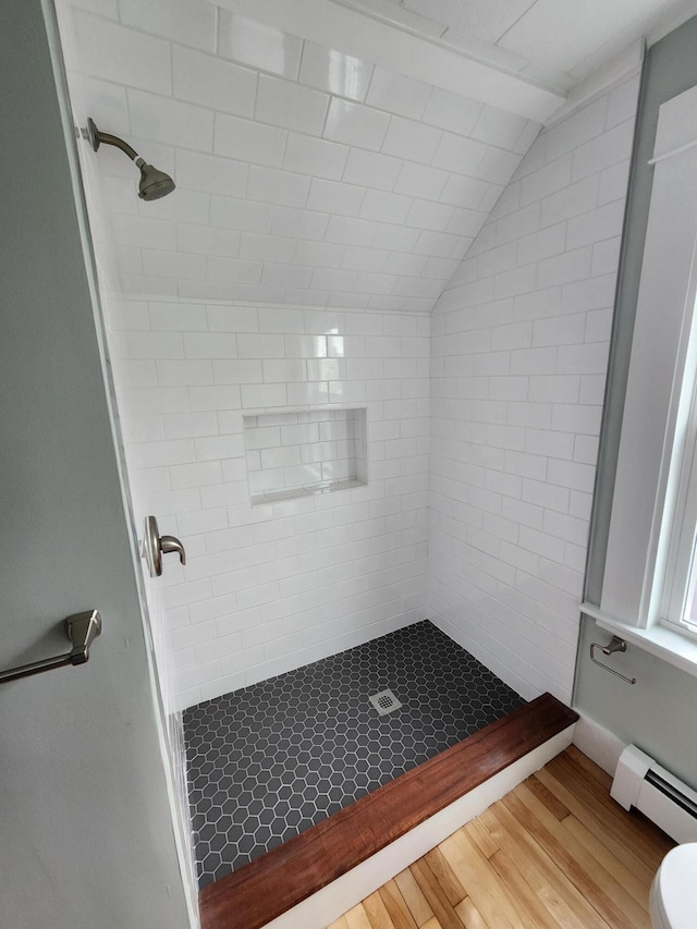 76 Somerset St, Millinocket, ME 04462 - bathroom featuring a baseboard radiator, wood finished floors, a shower stall, vaulted ceiling, and toilet