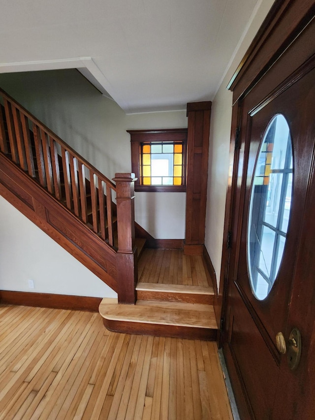 76 Somerset St, Millinocket, ME 04462 - foyer entrance with hardwood / wood-style floors, stairs, and baseboards