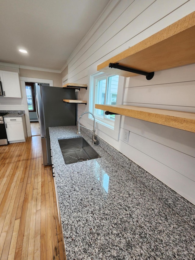 76 Somerset St, Millinocket, ME 04462 - kitchen with a sink, ornamental molding, open shelves, white cabinets, and plenty of natural light