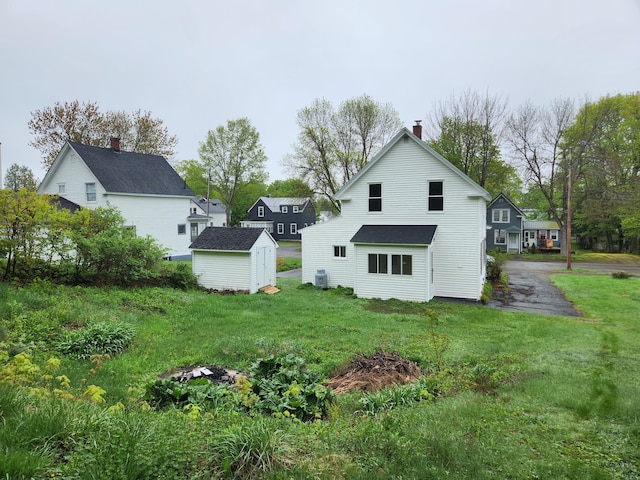 76 Somerset St, Millinocket, ME 04462 - rear view of house featuring a yard and a chimney