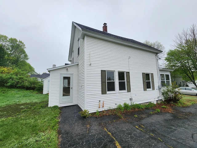 76 Somerset St, Millinocket, ME 04462 - view of side of property featuring a chimney