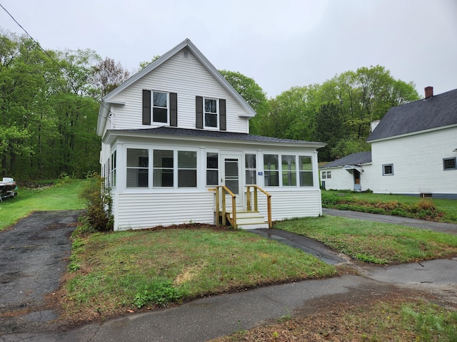 76 Somerset St, Millinocket, ME 04462 - view of front of house featuring a front yard and roof with shingles