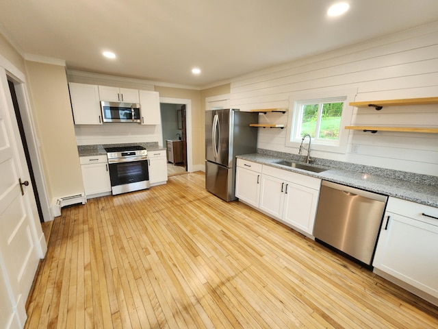 76 Somerset St, Millinocket, ME 04462 - kitchen with stainless steel appliances, a sink, open shelves, ornamental molding, and a baseboard radiator