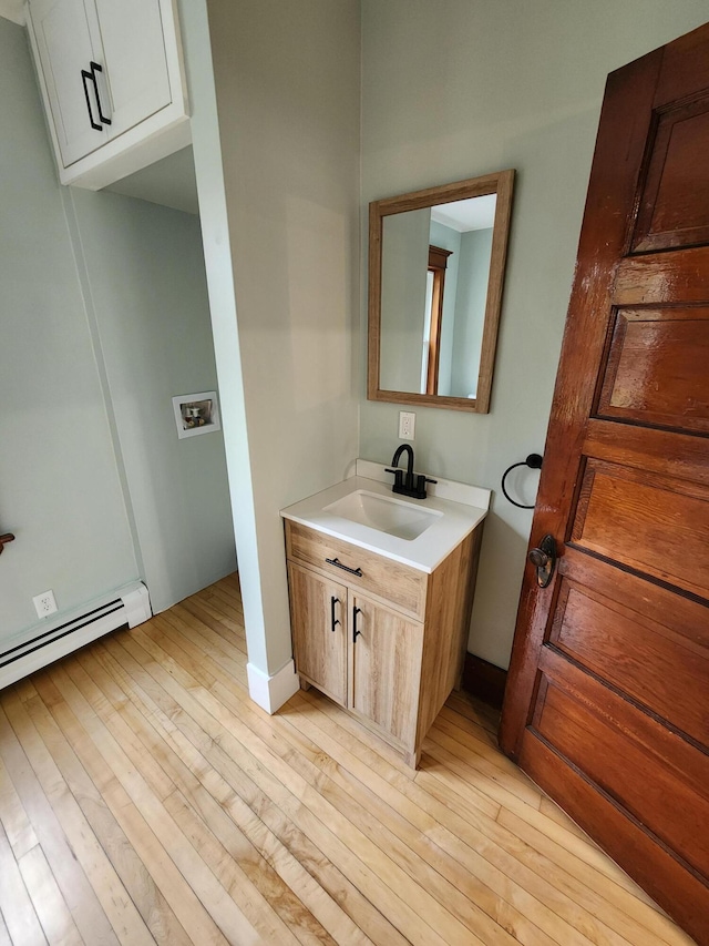 76 Somerset St, Millinocket, ME 04462 - bathroom featuring wood finished floors and vanity