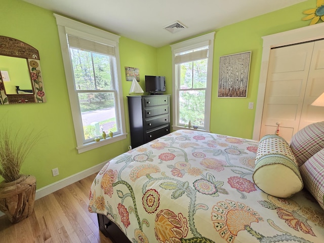 1 Old County Rd Unit 155, Wells, ME 04090 - bedroom with wood finished floors, multiple windows, and baseboards