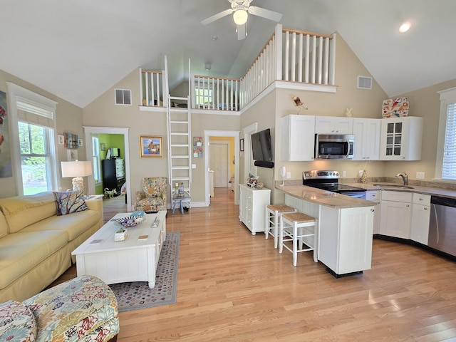 1 Old County Rd Unit 155, Wells, ME 04090 - living area featuring high vaulted ceiling, light wood-style floors, a ceiling fan, baseboards, and recessed lighting