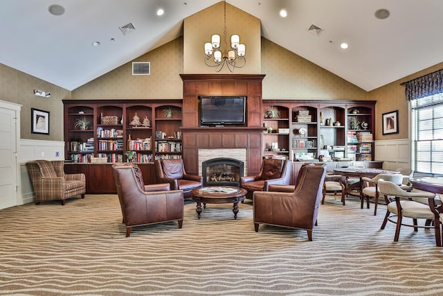1 Old County Rd Unit 155, Wells, ME 04090 - living area featuring high vaulted ceiling, a decorative wall, a chandelier, a wainscoted wall, and light carpet