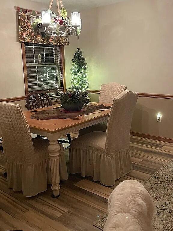 9 Deerfield Dr, Brunswick, ME 04011 - dining space featuring a chandelier, wood finished floors, and baseboards
