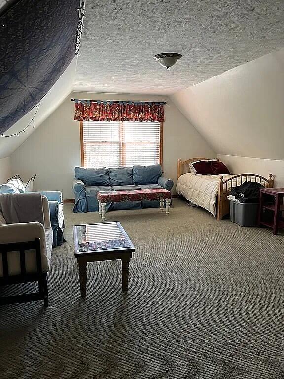 9 Deerfield Dr, Brunswick, ME 04011 - carpeted bedroom featuring lofted ceiling and a textured ceiling