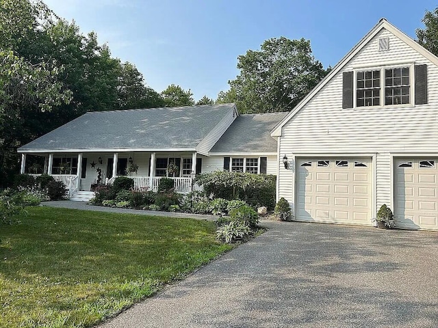 9 Deerfield Dr, Brunswick, ME 04011 - view of front of home featuring a porch, asphalt driveway, a front yard, and a garage