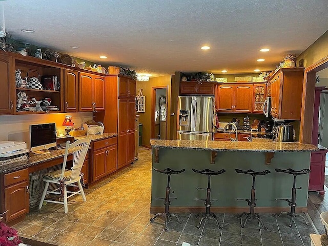 9 Deerfield Dr, Brunswick, ME 04011 - kitchen featuring stainless steel appliances, a peninsula, dark stone countertops, a breakfast bar, and recessed lighting