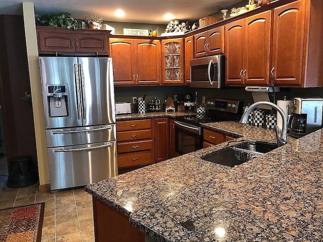 9 Deerfield Dr, Brunswick, ME 04011 - kitchen with stainless steel appliances, a sink, glass insert cabinets, and dark stone counters