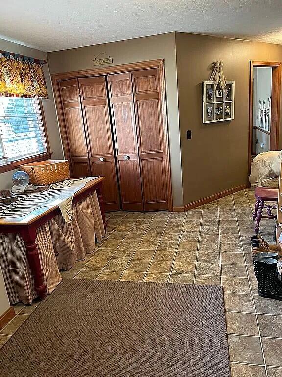 9 Deerfield Dr, Brunswick, ME 04011 - dining space with a textured ceiling, tile patterned floors, and baseboards