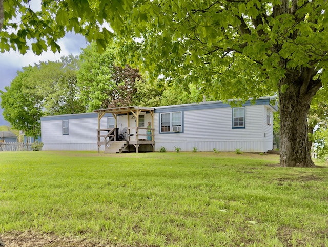 manufactured / mobile home featuring a front yard and cooling unit
