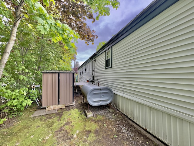 view of side of home featuring oil tank