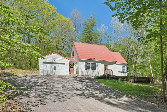 65 Lone Indian Trl, Augusta, ME 04330 - view of front of home featuring driveway, a garage, and metal roof