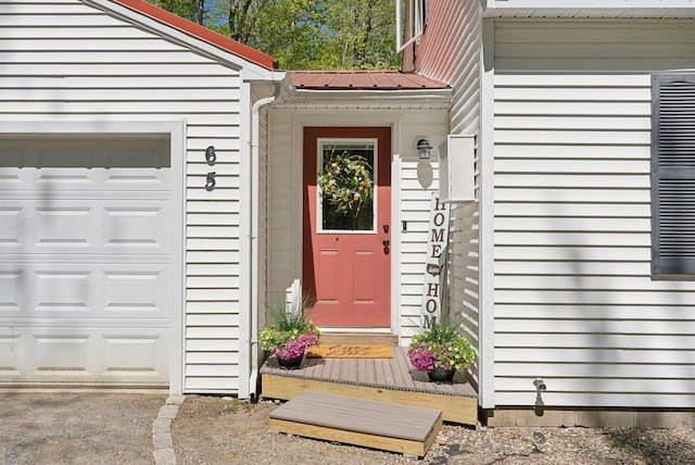65 Lone Indian Trl, Augusta, ME 04330 - doorway to property with a garage and metal roof