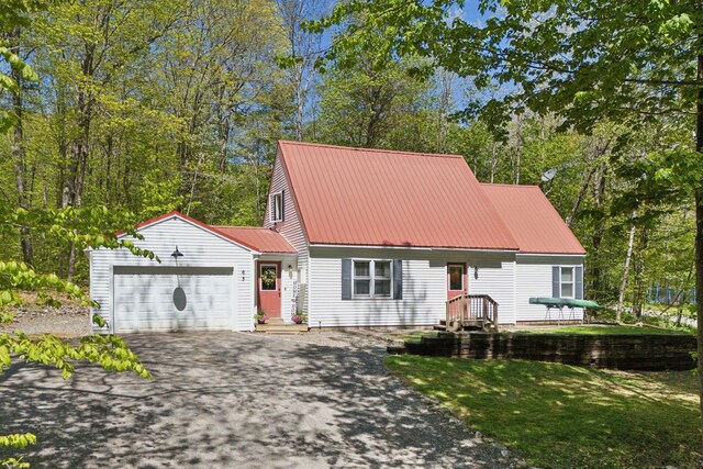 65 Lone Indian Trl, Augusta, ME 04330 - view of front of house with driveway, a garage, and metal roof