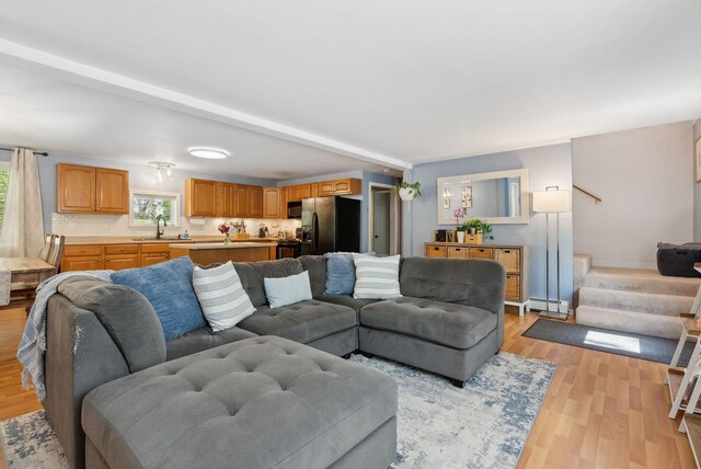65 Lone Indian Trl, Augusta, ME 04330 - living area featuring a baseboard radiator, light wood-style flooring, stairs, and baseboards