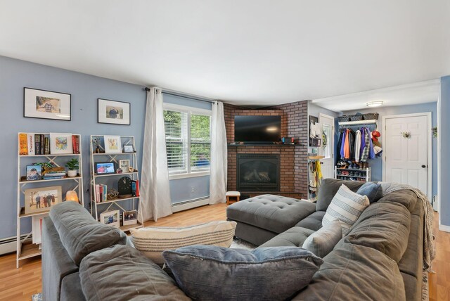 65 Lone Indian Trl, Augusta, ME 04330 - living room with a baseboard heating unit, wood finished floors, and a fireplace