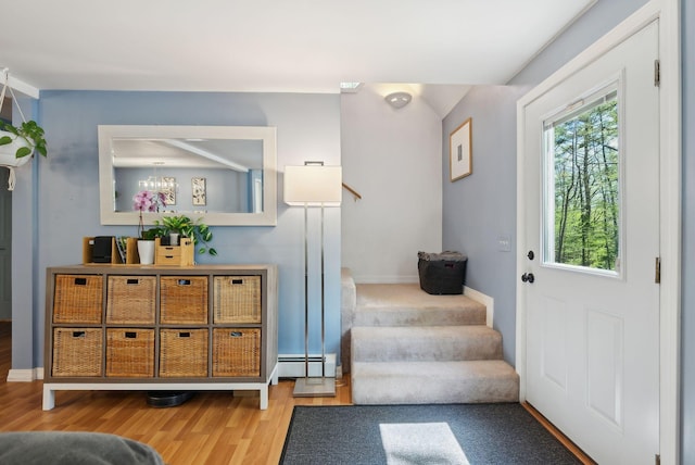 65 Lone Indian Trl, Augusta, ME 04330 - foyer entrance featuring wood finished floors, stairway, a baseboard heating unit, baseboards, and a chandelier