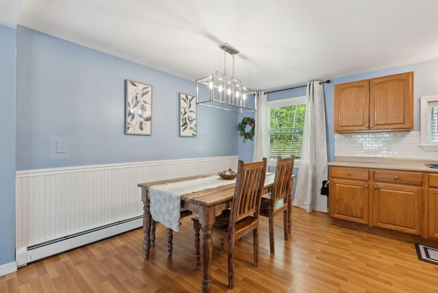 65 Lone Indian Trl, Augusta, ME 04330 - dining space featuring baseboard heating, light wood-style flooring, a wainscoted wall, and a chandelier