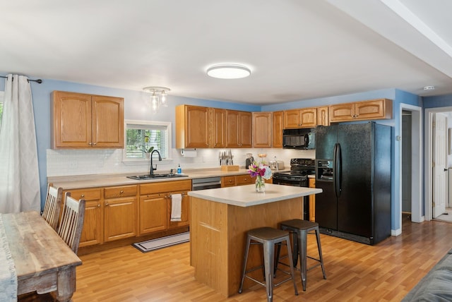 65 Lone Indian Trl, Augusta, ME 04330 - kitchen featuring black appliances, a sink, light wood-style flooring, and light countertops