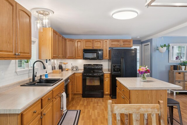 65 Lone Indian Trl, Augusta, ME 04330 - kitchen with black appliances, a sink, light countertops, light wood finished floors, and decorative backsplash