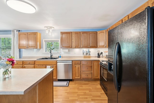 65 Lone Indian Trl, Augusta, ME 04330 - kitchen with black appliances, a sink, backsplash, and light countertops