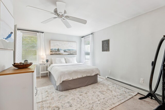 65 Lone Indian Trl, Augusta, ME 04330 - bedroom with multiple windows, baseboard heating, ceiling fan, and light carpet
