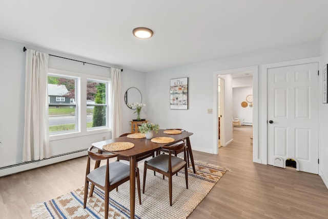 510 Minot Ave, Auburn, ME 04210 - dining room featuring light wood-style floors, a baseboard heating unit, and baseboards