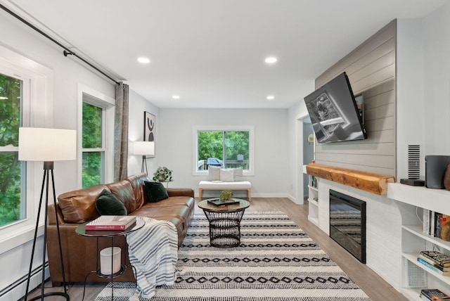 510 Minot Ave, Auburn, ME 04210 - living area featuring a baseboard heating unit, light wood-type flooring, recessed lighting, and a glass covered fireplace