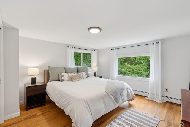 510 Minot Ave, Auburn, ME 04210 - bedroom with light wood-style floors and a baseboard radiator