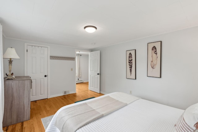 510 Minot Ave, Auburn, ME 04210 - bedroom with light wood finished floors, a baseboard radiator, crown molding, and baseboards
