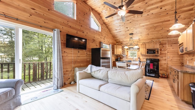 183 Pine Point Rd, Oxford, ME 04270 - living area featuring wooden walls, healthy amount of natural light, high vaulted ceiling, wood ceiling, and a ceiling fan