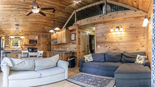 183 Pine Point Rd, Oxford, ME 04270 - living area featuring wood ceiling, ceiling fan, light wood-style floors, wooden walls, and high vaulted ceiling