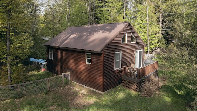 183 Pine Point Rd, Oxford, ME 04270 - view of side of home featuring a view of trees, log veneer siding, metal roof, and a wooden deck