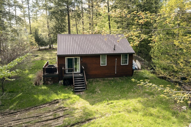 183 Pine Point Rd, Oxford, ME 04270 - view of front of home featuring a wooden deck, metal roof, and a forest view