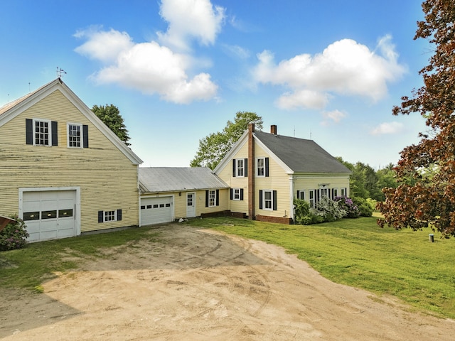 640 Lower St, Turner, ME 04282 - view of front of home with driveway, a front lawn, an attached garage, and a chimney