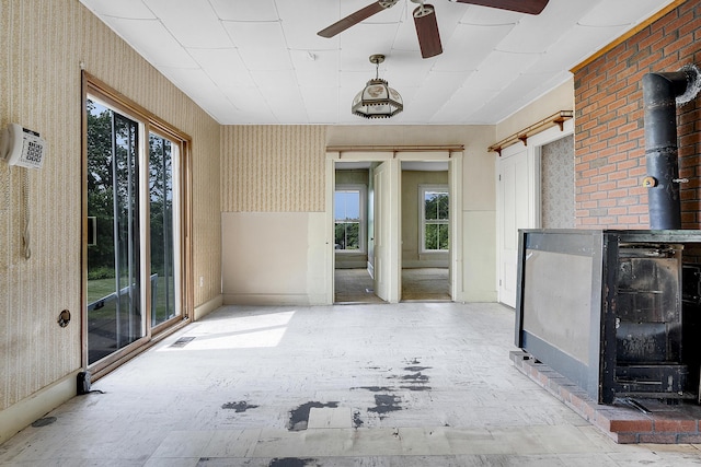 640 Lower St, Turner, ME 04282 - unfurnished sunroom with a wood stove and healthy amount of natural light