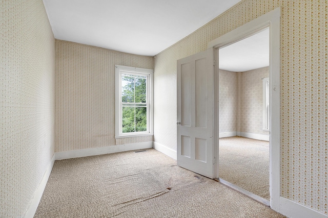 640 Lower St, Turner, ME 04282 - empty room with wallpapered walls, carpet floors, and baseboards